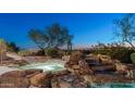 Relax in the hot tub with a waterfall feature and city views at 5316 E Valle Vista Rd, Phoenix, AZ 85018