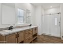 Bathroom with double vanity, large mirror, and glass shower at 53929 W Bowlin Rd, Maricopa, AZ 85139