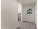 Bright entryway with tile flooring, leading to kitchen and exterior door at 6547 N 3Rd Ave, Phoenix, AZ 85013