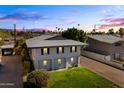 Two story house with gray exterior, landscaping, and driveway at 6547 N 3Rd Ave, Phoenix, AZ 85013