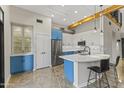 Modern kitchen with blue cabinets, stainless steel appliances, and an island at 914 E Osborn Rd # 208, Phoenix, AZ 85014