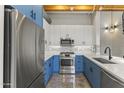 Modern kitchen with blue cabinetry and stainless steel appliances at 914 E Osborn Rd # 208, Phoenix, AZ 85014