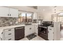 Kitchen with stainless steel appliances and white cabinets at 9428 W Taro Ln, Peoria, AZ 85382