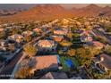 Aerial view showcasing a community with upscale homes, mountains, and desert landscape at 10335 E Acacia Dr, Scottsdale, AZ 85255