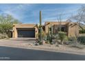Modern Southwestern home with dark garage door and drought-tolerant landscaping at 10585 E Crescent Moon Dr # 19, Scottsdale, AZ 85262