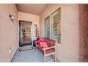 Inviting covered entryway featuring a bench, security door, and a pleasant, welcoming ambiance at 10851 E Sonrisa Ave, Mesa, AZ 85212