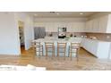 Modern kitchen with white cabinets, large island, and stainless steel appliances at 12539 W Parkway Ln, Avondale, AZ 85323
