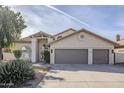 Two-story house with gray garage doors and landscaped front yard at 15804 S 15Th Pl, Phoenix, AZ 85048