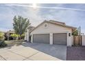 Two-story house with gray garage doors and landscaped front yard at 15804 S 15Th Pl, Phoenix, AZ 85048