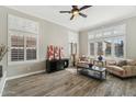 Living area with hardwood floors, plantation shutters, and comfy seating at 1714 E Saltsage Dr, Phoenix, AZ 85048