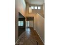 Two-story entryway with tiled floors and a view into the living room at 17322 W Carmen Dr, Surprise, AZ 85388