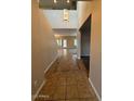 Bright entryway with tiled floors and a view into the living room at 17322 W Carmen Dr, Surprise, AZ 85388