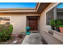 Inviting front entry with double doors and landscaping at 25239 S Glenburn Dr, Sun Lakes, AZ 85248