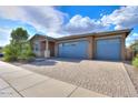 Beautiful single-story home showcasing a three-car garage and well-maintained landscaping at 40538 W Crane Dr, Maricopa, AZ 85138