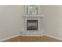 Gas fireplace with marble surround and wood mantel in a corner at 4213 E Edgemont Ave, Phoenix, AZ 85008