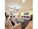 Bright and airy living room featuring a fireplace, modern furnishings, and a view to the kitchen at 4213 E Edgemont Ave, Phoenix, AZ 85008