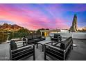 Amazing rooftop deck with city views, comfortable seating, and an umbrella for shade at 4214 E Marion Way, Phoenix, AZ 85018