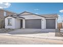 New construction home with a two-car garage and neutral exterior at 4235 E Brook Lynn Pl, San Tan Valley, AZ 85143
