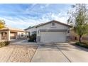 Neat home with a two-car garage, drought-resistant landscaping, and ample parking on the driveway at 743 E Horizon Heights Dr, San Tan Valley, AZ 85143
