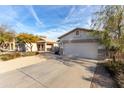 Residential home with a two-car garage, desert-style landscaping, and a concrete driveway at 743 E Horizon Heights Dr, San Tan Valley, AZ 85143