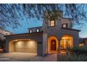 Charming home featuring a two-car garage and an inviting front porch with seating at 9305 E Canyon View Rd, Scottsdale, AZ 85255