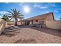 Landscaped backyard with gravel and a covered patio at 9544 W Sierra Pinta Dr, Peoria, AZ 85382