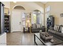 Bright living room with high ceilings, large windows, neutral walls and two cozy sofas at 126 E Key West Dr, Casa Grande, AZ 85122