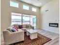 Spacious living room with L-shaped sofa, fireplace and large windows at 14825 S Charco Rd, Arizona City, AZ 85123