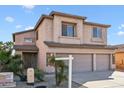 View of a well-maintained two-story home with a three-car garage and desert landscaping at 1801 W Nighthawk Way, Phoenix, AZ 85045