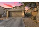 Two-story house with a two-car garage and desert landscaping at 18320 N Betty Ct, Maricopa, AZ 85138