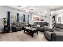 Spacious living room with two sofas, a coffee table, and carpet flooring at 18320 N Betty Ct, Maricopa, AZ 85138