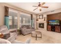 Comfortable living room featuring a fireplace and ample natural light at 20750 N 87Th St # 1065, Scottsdale, AZ 85255