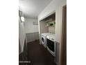 Bright laundry room with washer, dryer, and ample shelving at 2171 N Santiana Pl, Casa Grande, AZ 85122