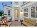 Covered patio with seating area, near the front entry at 30093 N 129Th Dr, Peoria, AZ 85383