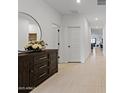 Bright entryway with wood-toned dresser and large mirror at 35208 W Santa Monica Ave, Maricopa, AZ 85138