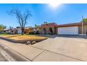 Ranch style home with a two-car garage and mature trees at 4227 W Hatcher Rd, Phoenix, AZ 85051
