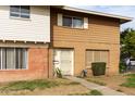 Two-story townhome with brown and white exterior, landscaping, and a walkway at 4354 W Maryland Ave, Glendale, AZ 85301