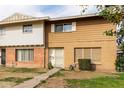 Two-story townhome with brown and white exterior, landscaping, and a walkway at 4354 W Maryland Ave, Glendale, AZ 85301