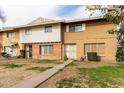 Two-story townhome with brown and white exterior, landscaping, and a walkway at 4354 W Maryland Ave, Glendale, AZ 85301
