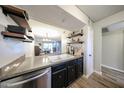 Kitchen features a double sink, dark cabinetry, and open shelving at 7436 E Chaparral Rd # B110, Scottsdale, AZ 85250