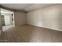 Open living area with tile floors and access to kitchen at 8520 W Palm Ln # 1021, Phoenix, AZ 85037