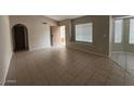 Spacious living room with tile floors and neutral walls at 8520 W Palm Ln # 1021, Phoenix, AZ 85037
