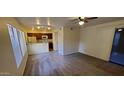 Open living area with kitchen, carpet, and sliding glass door at 1432 W Emerald Ave # 647, Mesa, AZ 85202