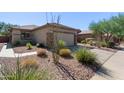 Front view of a house with a well-manicured yard at 1713 W Morse Dr, Anthem, AZ 85086