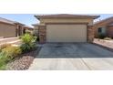 Two-car garage with neutral-colored door and stone accents at 1713 W Morse Dr, Anthem, AZ 85086