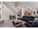 Inviting living room featuring a staircase, hardwood floors, and comfortable seating adjacent to a kitchen at 3241 E Aris Dr, Gilbert, AZ 85298