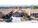 An aerial view of the single-Gathering home showcasing its desert landscaping and neighborhood at 514 S 224Th Dr, Buckeye, AZ 85326