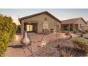 Private backyard with desert landscaping, covered patio, and an outdoor dining area perfect for entertaining at 514 S 224Th Dr, Buckeye, AZ 85326
