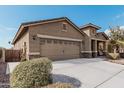 A well-maintained two-car garage door and a wide driveway enhance the curb appeal of this home at 514 S 224Th Dr, Buckeye, AZ 85326