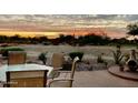 Peaceful patio setting at sunset with outdoor furniture and fire pit at 514 S 224Th Dr, Buckeye, AZ 85326